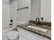 Bathroom featuring a vanity with sink and faucet, a shower, and a toilet at 766 Chapman St, Jonesboro, GA 30238