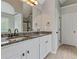 Bathroom featuring double sinks with granite countertops and white cabinets at 766 Chapman St, Jonesboro, GA 30238