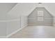 Bedroom with light gray walls, a window, baseboards, and wood-look flooring at 766 Chapman St, Jonesboro, GA 30238