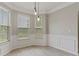 Charming dining area with large windows, paneled walls, and contemporary lighting at 766 Chapman St, Jonesboro, GA 30238