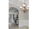 Light filled dining room with gray walls, white trim, arches, wood-look floors, and chandelier at 766 Chapman St, Jonesboro, GA 30238