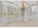 Light filled dining room with gray walls, white trim, arches, wood-look floors, and bay window at 766 Chapman St, Jonesboro, GA 30238