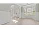 Light filled dining room with gray walls, white trim, arches, wood-look floors, and bay window at 766 Chapman St, Jonesboro, GA 30238