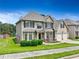 Two-story home with tan siding, brick accents, two-car garage and well-manicured lawn near the water at 766 Chapman St, Jonesboro, GA 30238