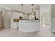 Open-concept kitchen featuring a breakfast bar, white cabinets, and modern pendant lighting at 766 Chapman St, Jonesboro, GA 30238