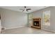 Spacious living room with a brick fireplace, ceiling fan, and natural light from large windows at 766 Chapman St, Jonesboro, GA 30238