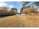 Large backyard with wood and chainlink fences surrounding a white brick house at 935 Conley Se Rd, Atlanta, GA 30354
