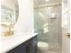 Modern bathroom with glass-enclosed shower, gold fixtures, updated vanity, and neutral colors at 935 Conley Se Rd, Atlanta, GA 30354