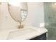 Modern sink and faucet, white countertop, gold mirror, and shower with gray tile at 935 Conley Se Rd, Atlanta, GA 30354