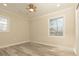 Bedroom featuring stylish wood-look flooring, neutral paint, and natural light at 935 Conley Se Rd, Atlanta, GA 30354