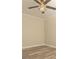 A well-lit bedroom with light gray hardwood floors, a modern ceiling fan, and fresh paint at 935 Conley Se Rd, Atlanta, GA 30354