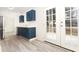 Stylish kitchen with stainless steel appliances, blue cabinetry, bright white countertops, and a modern backsplash at 935 Conley Se Rd, Atlanta, GA 30354