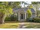 Charming home with a well-maintained lawn, mature trees and inviting front porch and gray siding at 954 Bouldercrest Se Dr, Atlanta, GA 30316