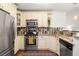 Efficient kitchen with stainless steel appliances, granite countertops, and custom tile backsplash and cabinets at 954 Bouldercrest Se Dr, Atlanta, GA 30316