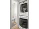 Conveniently located laundry area with stacked washer and dryer, maximizing space and efficiency and shelving at 954 Bouldercrest Se Dr, Atlanta, GA 30316