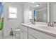 Bathroom featuring dual sinks set in white cabinets, and shower with tile surround at 148 Sierra Cir, Woodstock, GA 30188