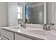 Bathroom featuring dual sinks set in white cabinets, with brushed nickel faucets at 148 Sierra Cir, Woodstock, GA 30188