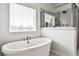 Stylish bathroom with a soaking tub, a tiled shower and plenty of natural light at 148 Sierra Cir, Woodstock, GA 30188