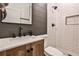 Modern bathroom featuring a wood vanity, white subway tile shower, and black fixtures at 148 Sierra Cir, Woodstock, GA 30188
