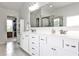 Bright bathroom featuring a double vanity, modern fixtures and a walk-in closet at 148 Sierra Cir, Woodstock, GA 30188