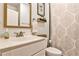 Well-lit bathroom with a framed mirror, marble countertop, and patterned shower curtain at 148 Sierra Cir, Woodstock, GA 30188