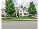 Beautiful two-story home featuring a well-manicured lawn and lush landscaping at 148 Sierra Cir, Woodstock, GA 30188