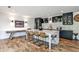 Stylish kitchen with a large island, barstool seating, stainless steel appliances, and hardwood floors at 148 Sierra Cir, Woodstock, GA 30188