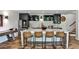 Stylish kitchen with a large island, barstool seating, stainless steel appliances, and hardwood floors at 148 Sierra Cir, Woodstock, GA 30188