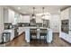Bright kitchen with white cabinets, stainless steel appliances, island and dark countertops at 148 Sierra Cir, Woodstock, GA 30188