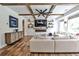 Beautiful living room with coffered ceilings, a fireplace, a large screen TV, and hardwood floors at 148 Sierra Cir, Woodstock, GA 30188