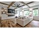 Beautiful living room with coffered ceilings, a fireplace, a large screen TV, and hardwood floors at 148 Sierra Cir, Woodstock, GA 30188