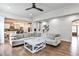 Spacious living room with hardwood floors, a large comfortable couch, and open access to the kitchen at 148 Sierra Cir, Woodstock, GA 30188