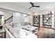 Bright living room featuring hardwood floors, large comfortable couch, and wooden bookshelves at 148 Sierra Cir, Woodstock, GA 30188