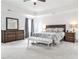 Cozy main bedroom with natural light, featuring neutral colors and a wooden dresser at 148 Sierra Cir, Woodstock, GA 30188