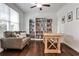 Bright home office features custom shelving, sofa and hardwood floors at 148 Sierra Cir, Woodstock, GA 30188