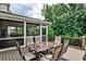 Back patio with an outdoor dining set, backing to wooded area at 148 Sierra Cir, Woodstock, GA 30188