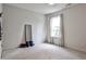 Minimalist room with neutral carpet, mirror and large window at 148 Sierra Cir, Woodstock, GA 30188