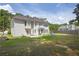 Large backyard with a patio, well-manicured lawn, mature trees and outdoor play set at 250 Lawrence Pl, Atlanta, GA 30349