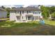 Spacious backyard featuring a patio, lush green grass, and mature trees, perfect for outdoor activities at 250 Lawrence Pl, Atlanta, GA 30349