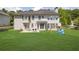 View of the home's rear exterior and spacious lawn, enhanced by a patio and play equipment in the backyard at 250 Lawrence Pl, Atlanta, GA 30349