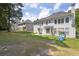 Expansive backyard with lush green lawn, patio, mature trees, and play area, perfect for outdoor living at 250 Lawrence Pl, Atlanta, GA 30349