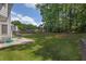 Well-maintained backyard with green grass, trees, and patio, ideal for entertaining and relaxation at 250 Lawrence Pl, Atlanta, GA 30349