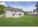 The backyard shows a well-maintained lawn, complemented by the home's exterior and a small patio with outdoor furniture at 250 Lawrence Pl, Atlanta, GA 30349