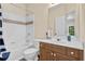 Bathroom with tub and shower combination, toilet, and single sink vanity with white countertops at 250 Lawrence Pl, Atlanta, GA 30349