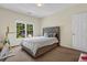 Bright bedroom with a large window and neutral decor; features a comfortable bed and ample space at 250 Lawrence Pl, Atlanta, GA 30349