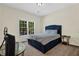 This bright, comfortable bedroom features a blue upholstered bed frame and a large window for natural light at 250 Lawrence Pl, Atlanta, GA 30349