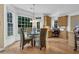 Charming dining area with large windows and a view of the backyard's lush greenery at 250 Lawrence Pl, Atlanta, GA 30349