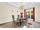 Formal dining room featuring tray ceilings, a chandelier, and ample natural light at 250 Lawrence Pl, Atlanta, GA 30349