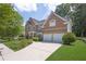 Beautiful brick home with a two-car garage, long driveway, and manicured front lawn at 250 Lawrence Pl, Atlanta, GA 30349