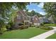Lovely two-story brick home with a well-kept lawn and mature trees at 250 Lawrence Pl, Atlanta, GA 30349